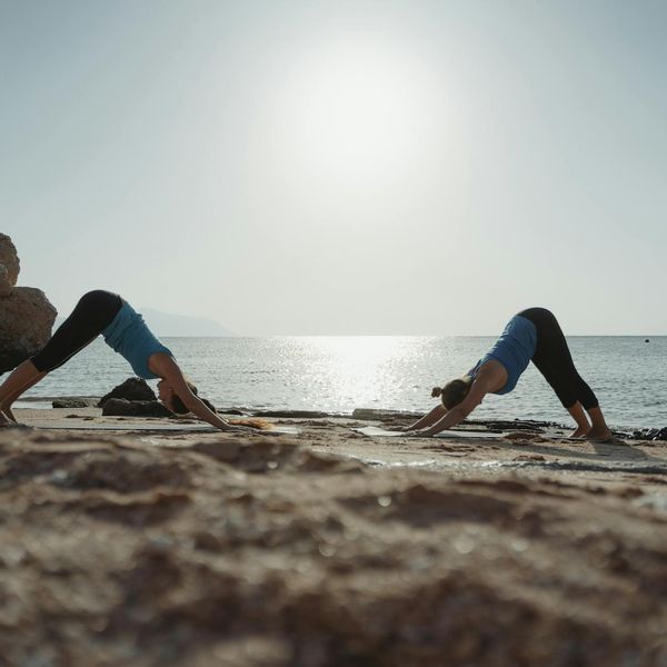 Person stretching outdoors during sunrise, showing flexibility.